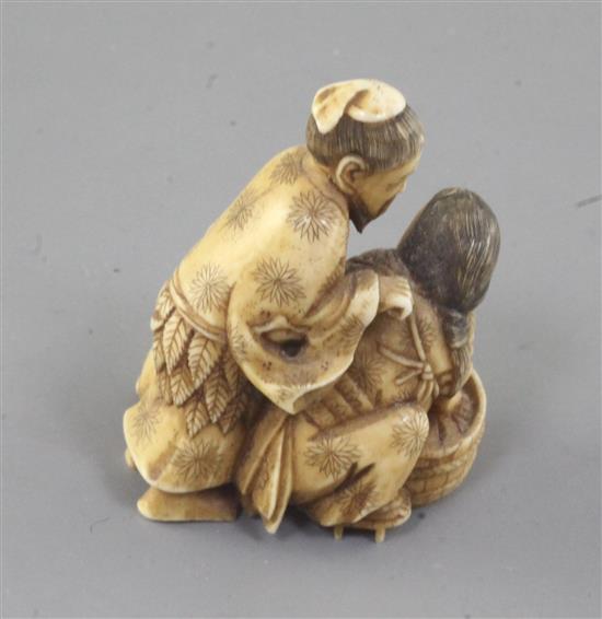 A Japanese ivory okimono of a family group, Meiji period, 4.5cm high (no. 522)